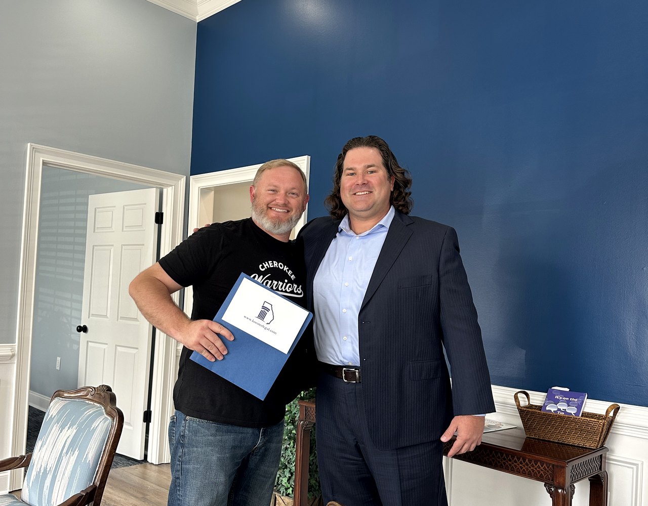 Kyle Koester with a local client at his Woodstock office